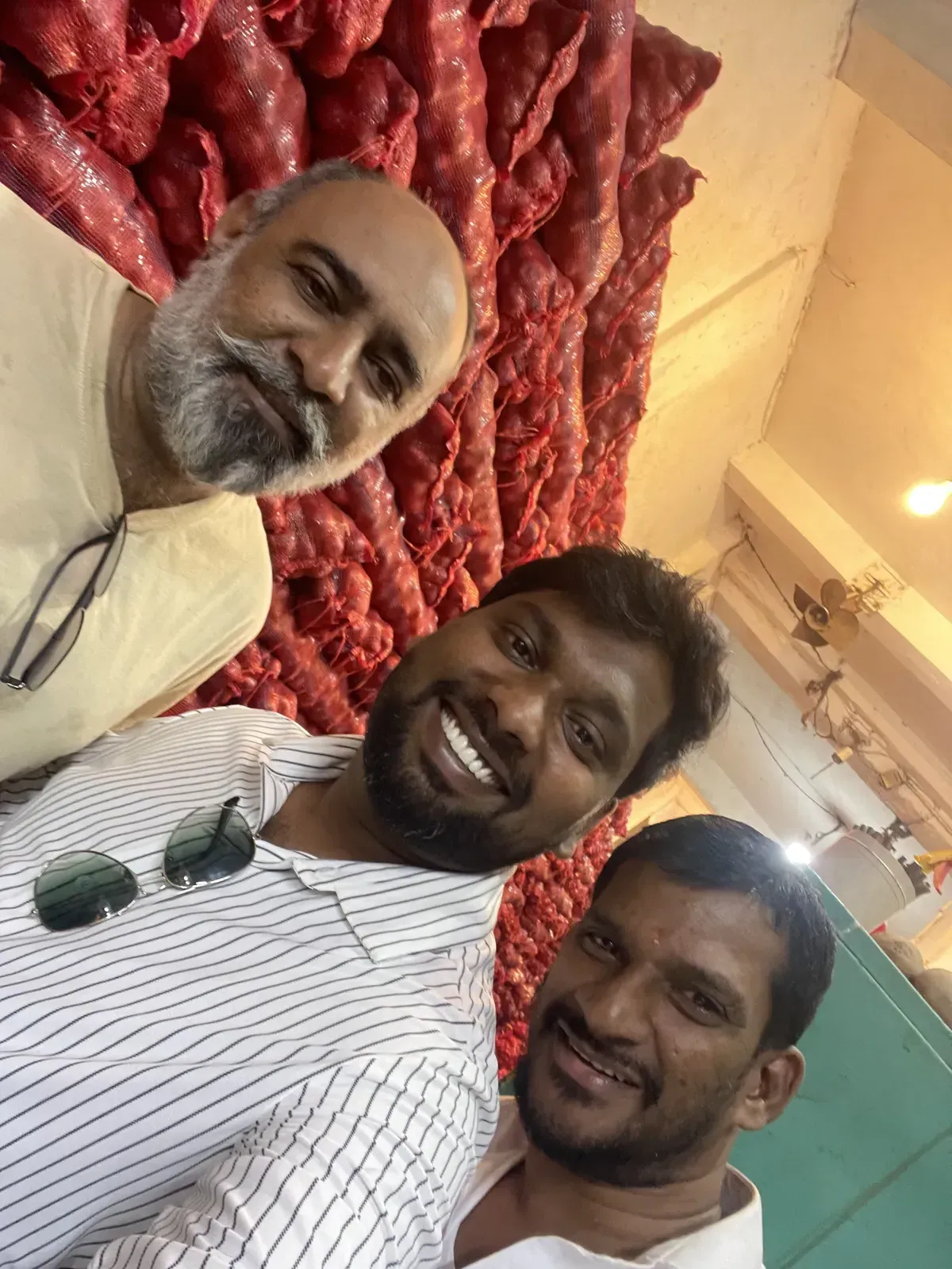Onion traders from Pakistan, India and Sri Lanka together at a Pettah Market store in front of onion sacks